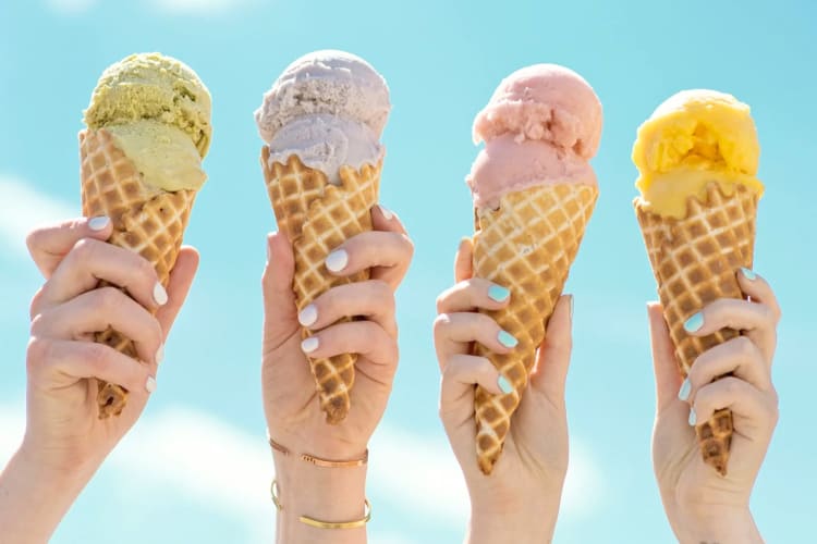 Four people holding ice cream cones