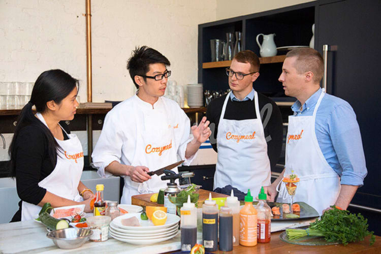 Three people taking a cooking class with an expert chef — great for a team building activity in D.C.