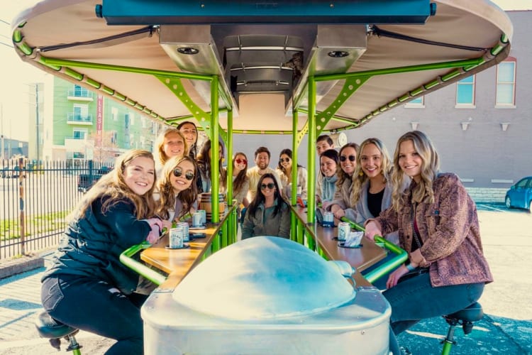 People on a pedal bike bar