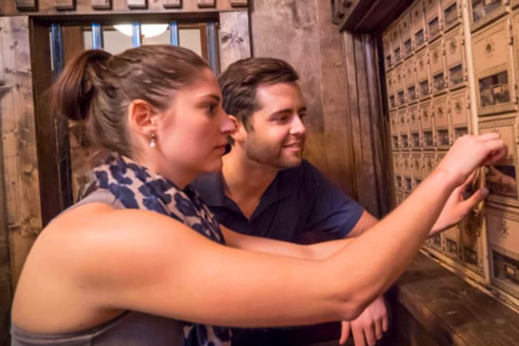Two people completing an escape room game