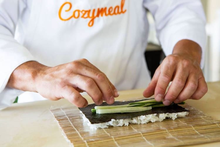 A chef rolling sushi