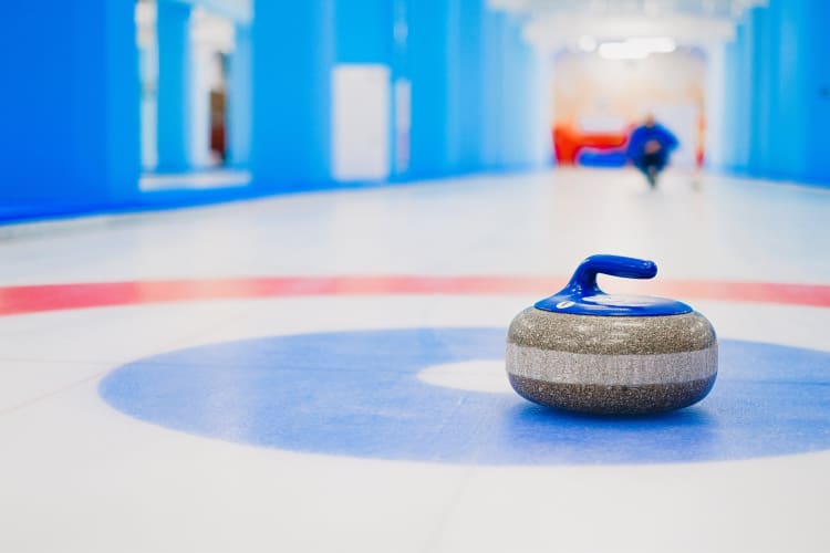 Going curling is one of the unique team building activities in Naperville