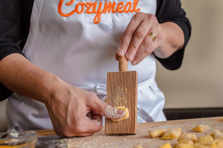 A Cozymeal chef prepares pasta.