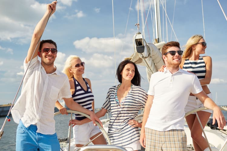 A group of happy people on board a sailing boat.