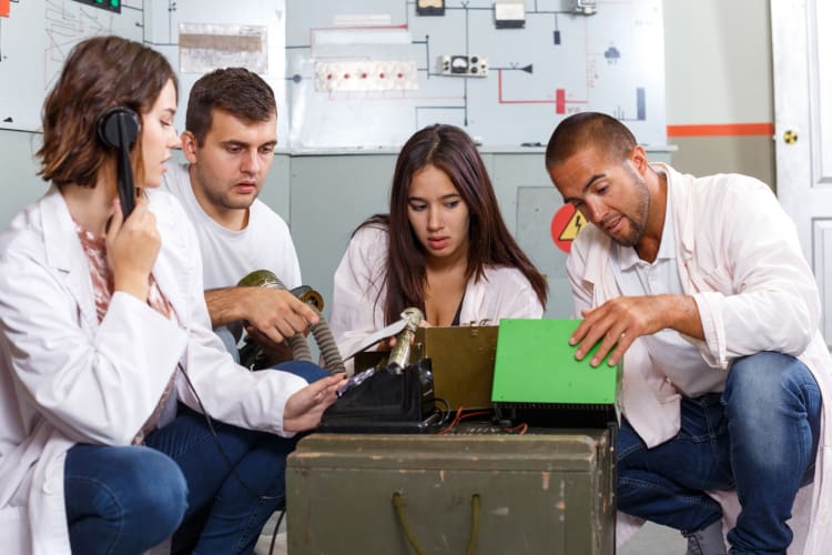 Four people playing an escape game