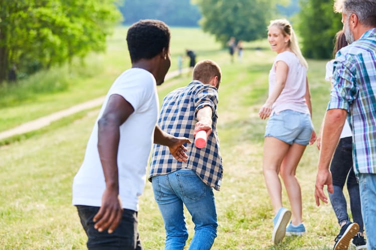 Person handing a baton over to someone else during a relay race