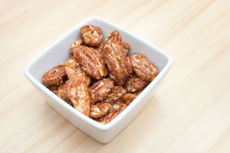 A bowl of sugared pecans.
