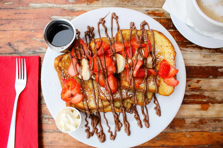 Aerial view of French toast covered in fruit and chocolate sauce, from The Filling Station Café, a diner in Orange County