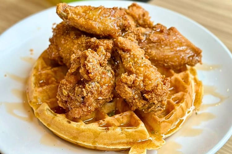 Chicken and waffles drizzled in syrup, from The Hudson Café, a birthday restaurant in Detroit