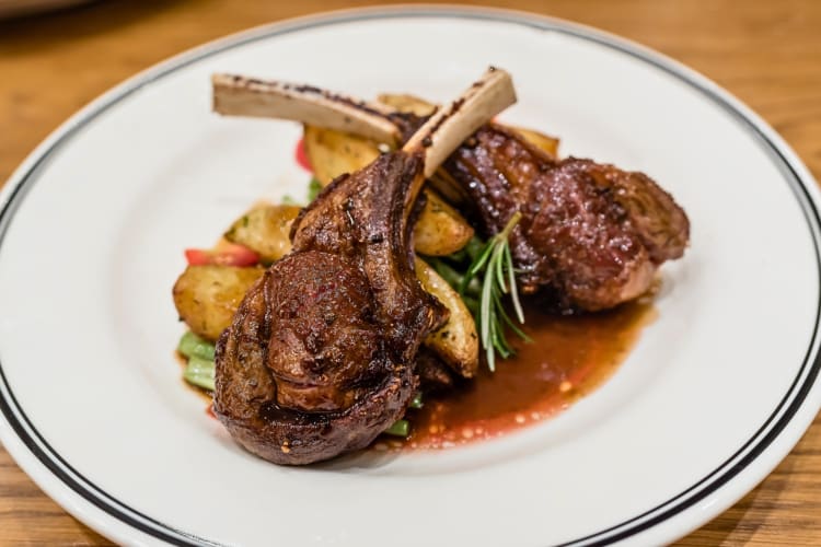 Two lamb chops on potatoes and vegetables