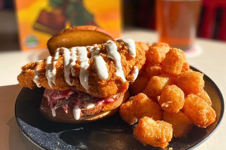 Chicken sandwich with chicken pieces on the side from Thirsty Dice