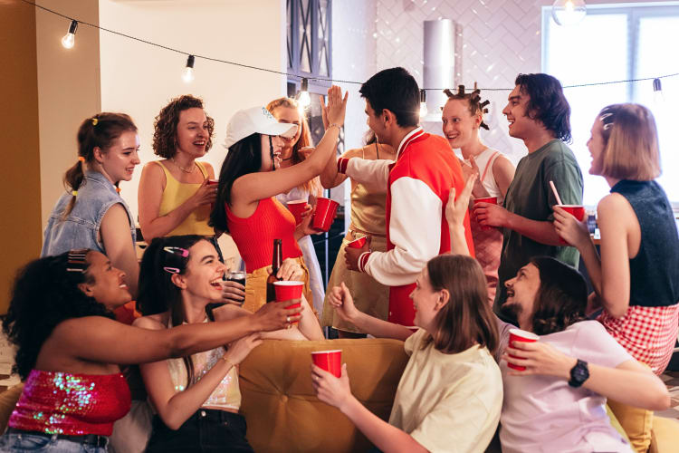 Young adults having fun at a 90s themed party as an adult birthday party idea