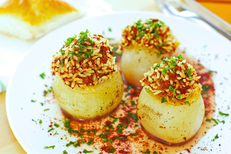 Three stuffed onions on a plate