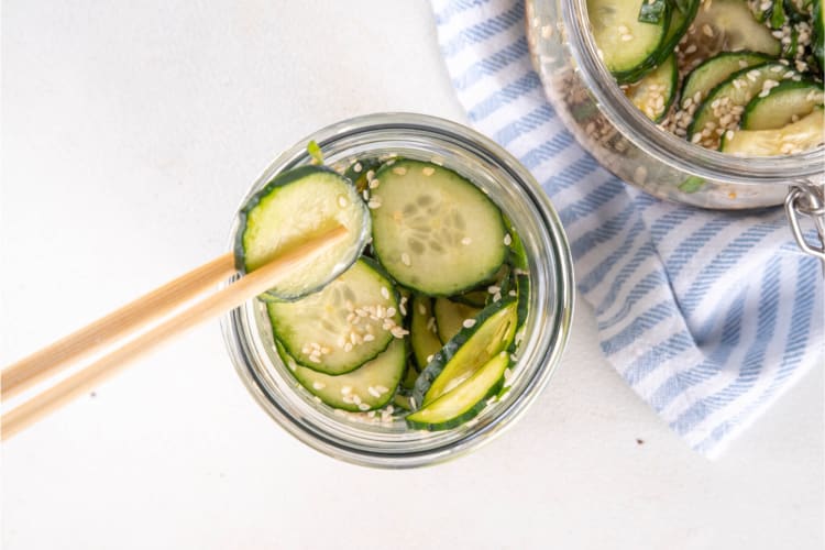 Eating a cucumber salad with chopsticks