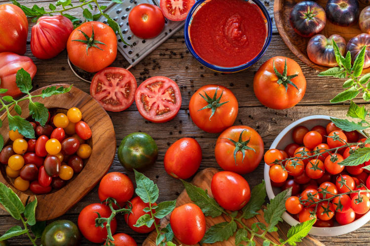 Different types of fresh tomatoes on a table