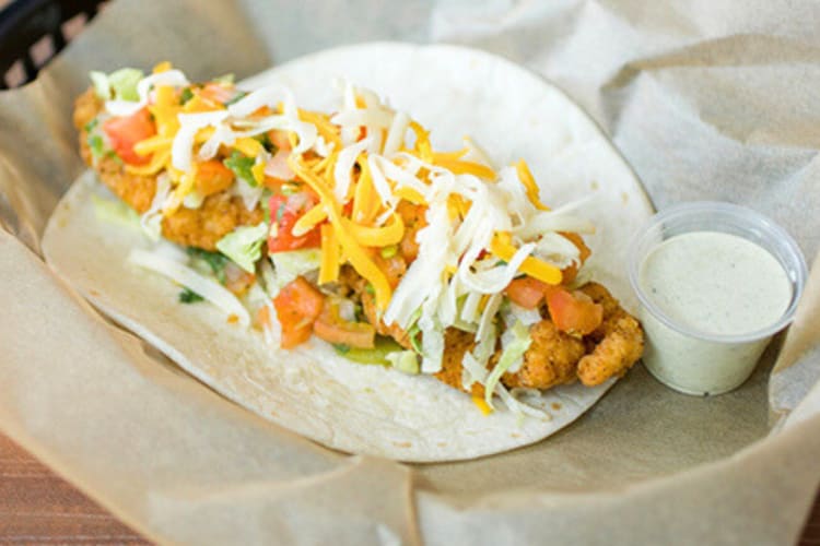 A taco with crispy chicken and cheese