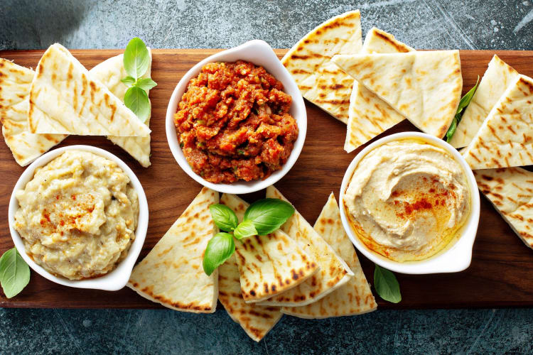 Pita bread and dips on a board