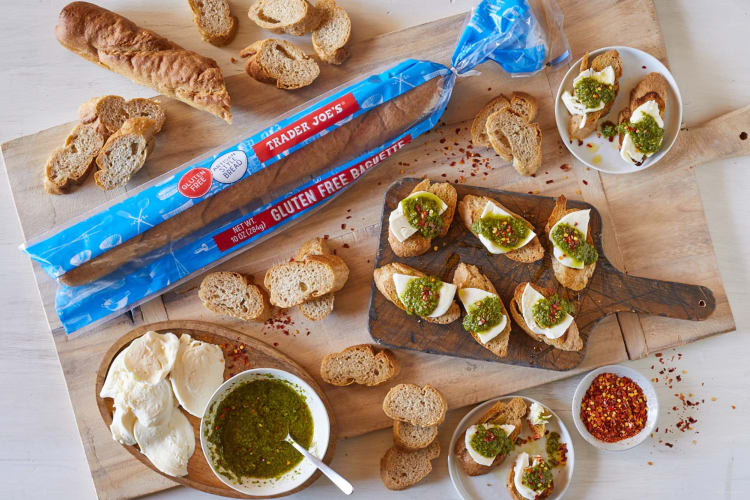 Slices of baguette with fresh mozzarella, pesto and chile flakes