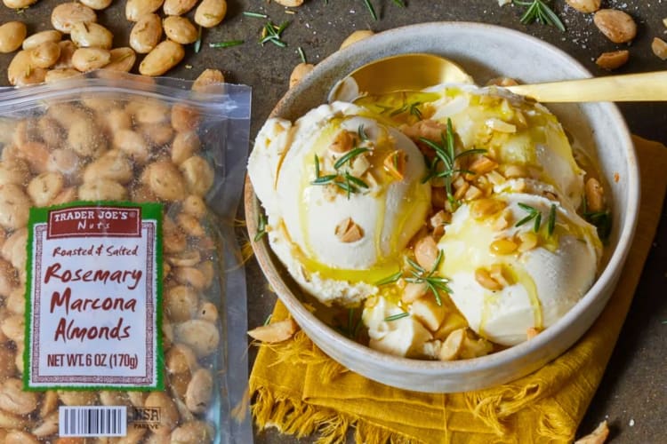 A bowl of olive oil ice cream next to rosemary marcona almonds