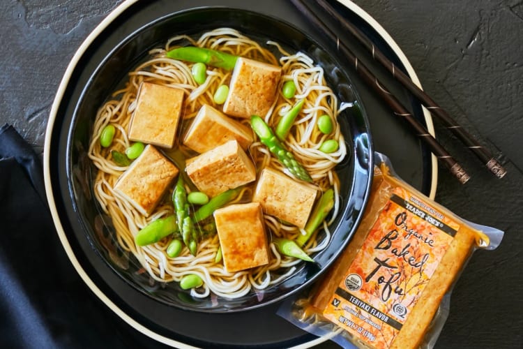 A bowl of tofu and noodle soup