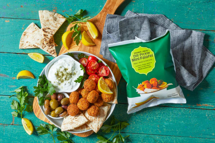 Falafel, pita and dip next to a bag of Dill Pickle Mini Falafel