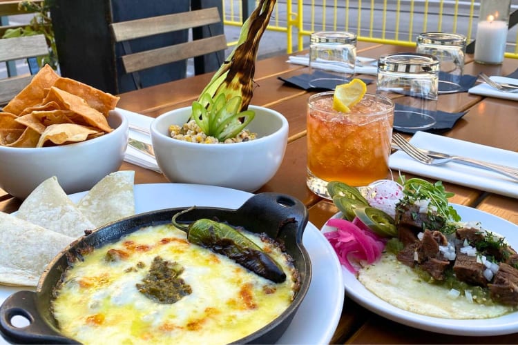 A selection of Mexican-style dishes and drinks on an outdoor table