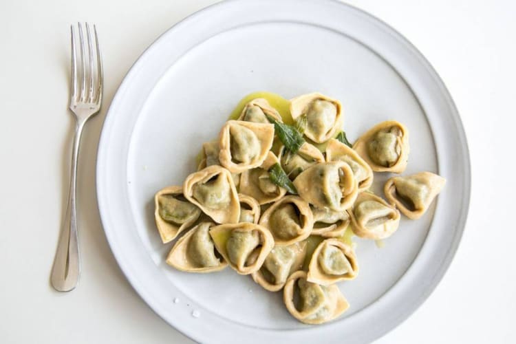 Tortellini pasta in a bowl with oil and sage