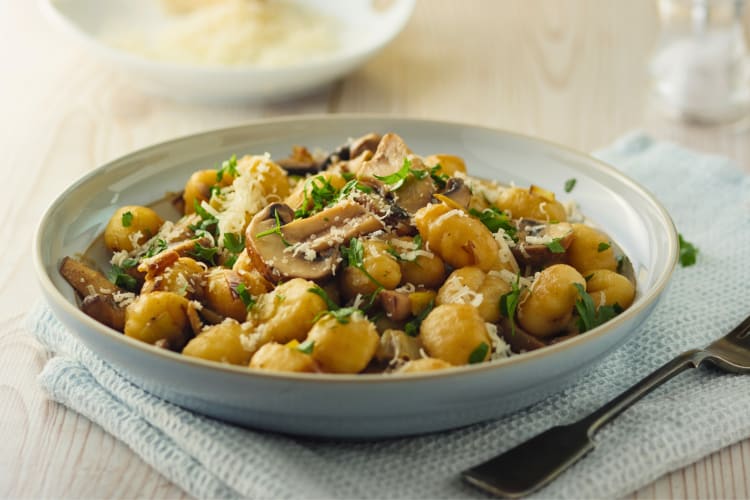 A bowl of gnocchi pasta with mushrooms