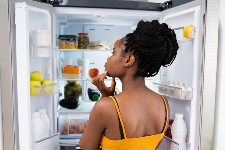 A woman looking in the refrigerator 