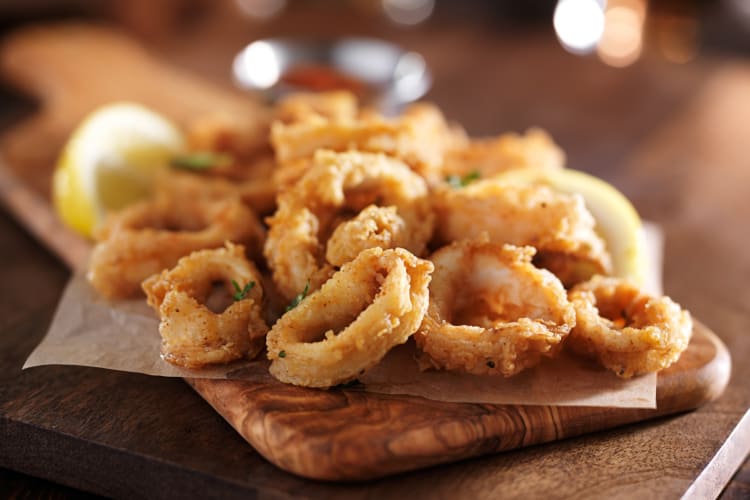 Fried calamari on a wooden board