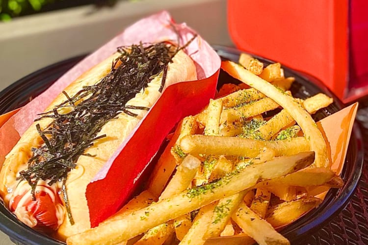 A hot dog with nori next to fries with herb seasoning