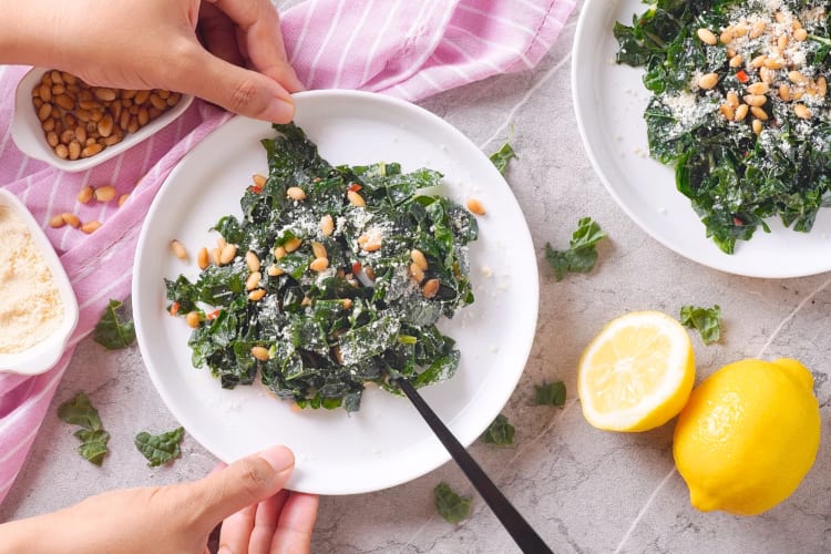 A lemon and kale salad with pine nuts