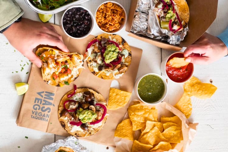 Veggie tacos and tortilla chips on a table