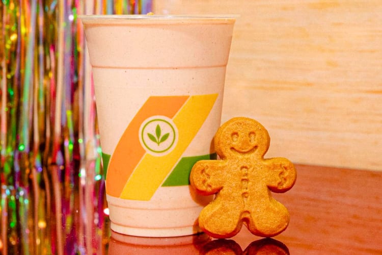 A gingerbread man next to a smoothie