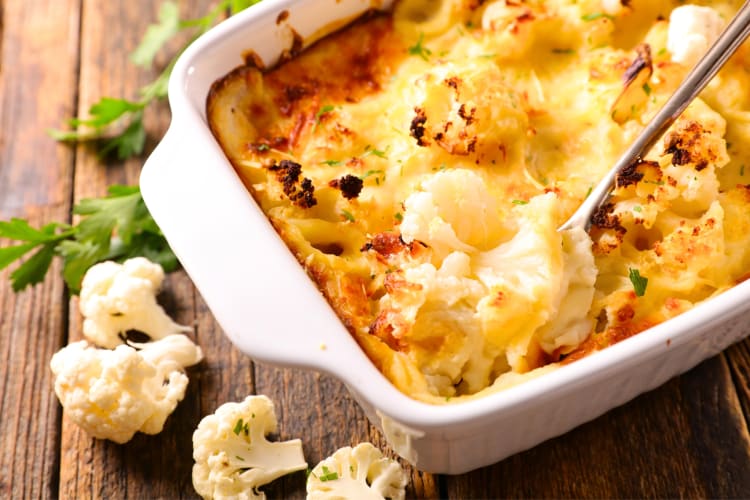 A dish with cauliflower au gratin next to cauliflower florets