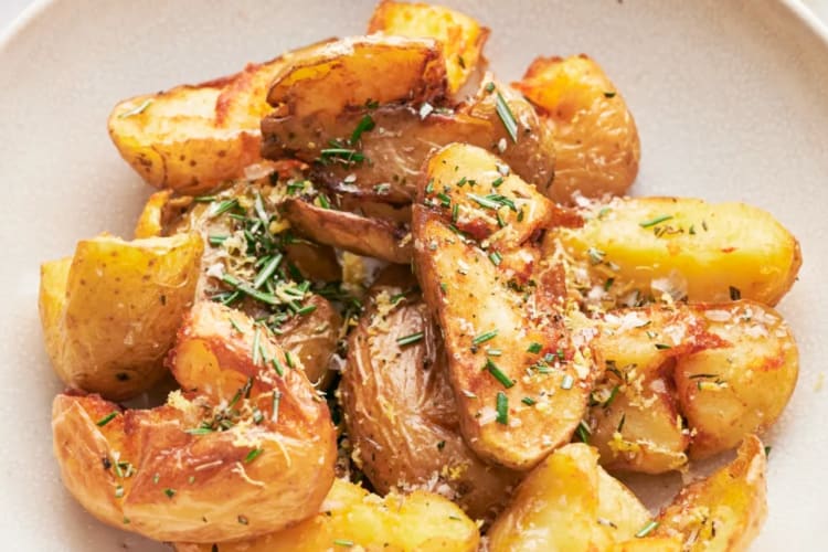Roasted potatoes in a bowl sprinkled with rosemary