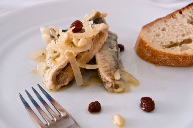 Sardines, onions, pine nuts and raisins