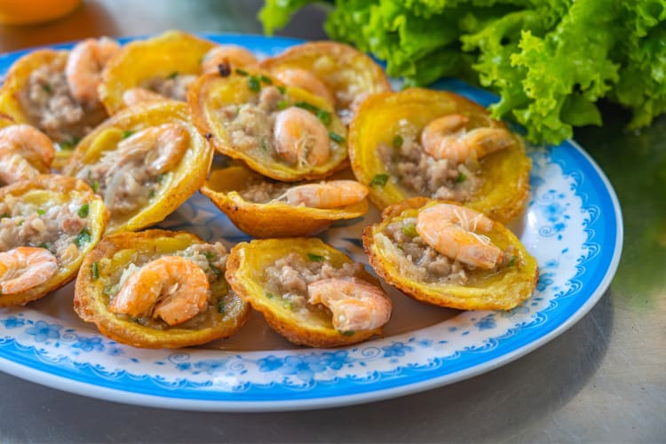 Small, round shrimp pancakes on a blue plate
