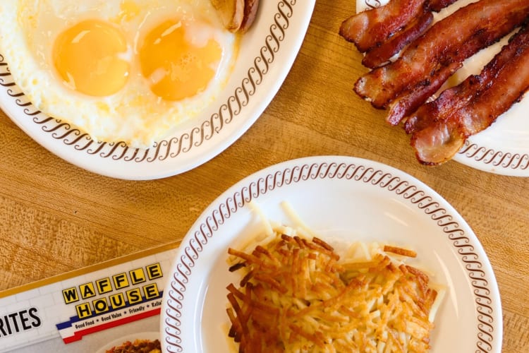 Bacon, eggs and hashbrowns next to a Waffle House menu