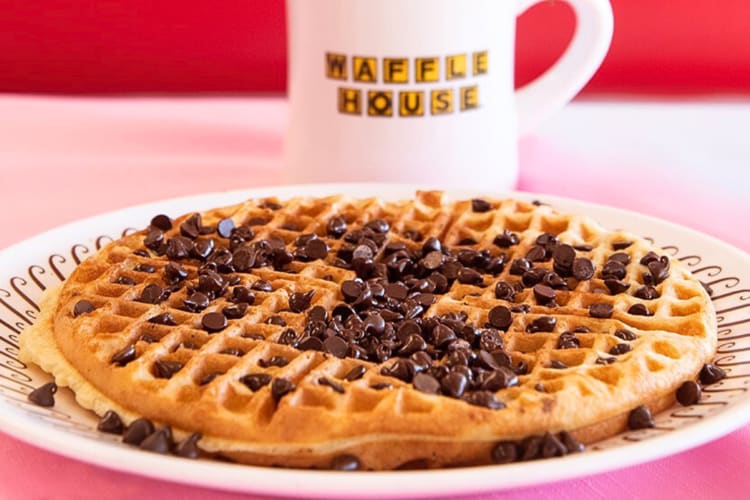 Chocolate chip waffle in front of a mug, from Waffle House, a diner in Kansas City