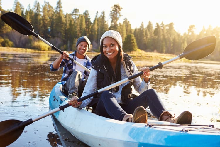 A couple kayaking together in one boat