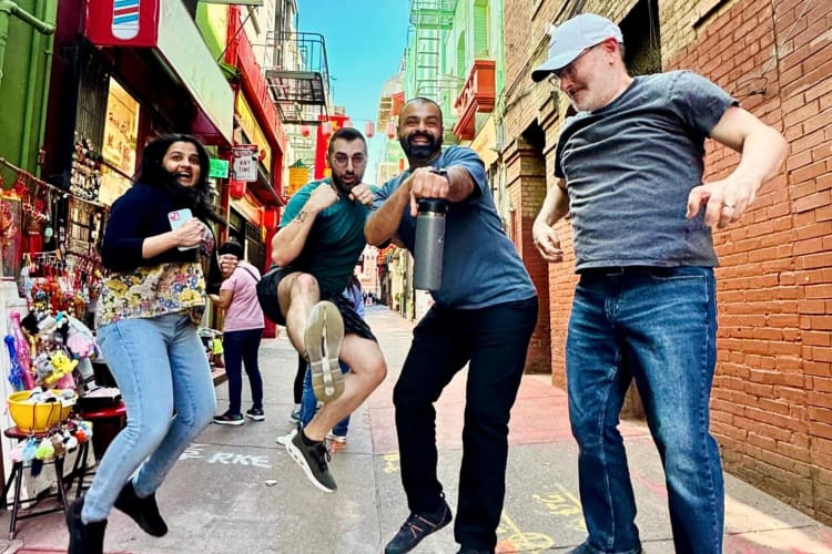 Four people jumping in excitement during a scavenger hunt as a team building activity in Las Vegas