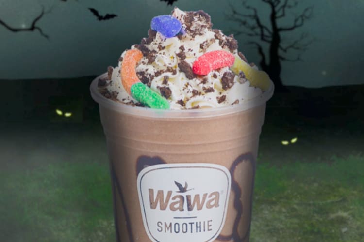 A chocolate milkshake with whipped cream and gummy worms