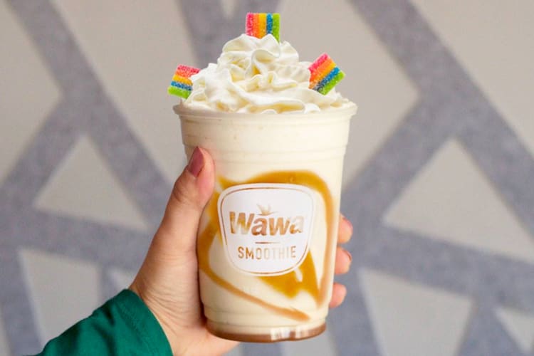 A caramel milkshake with whipped cream and rainbow candy