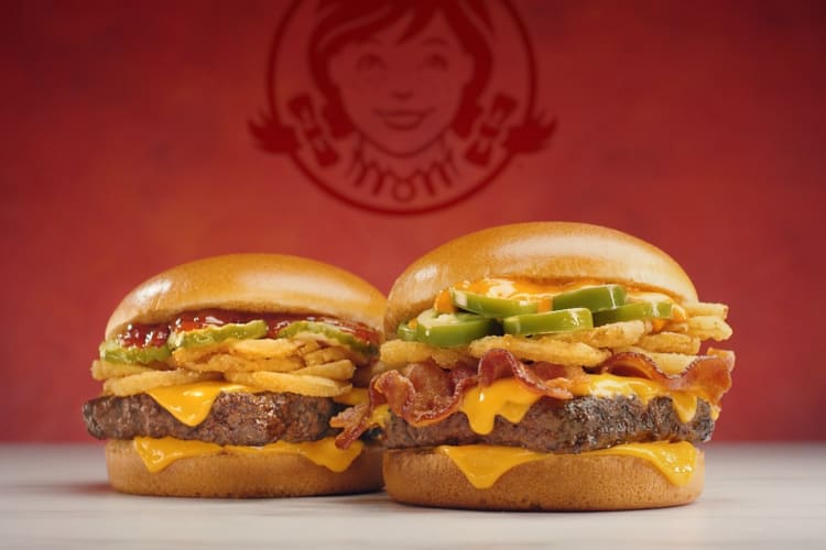 Two burgers on a red background