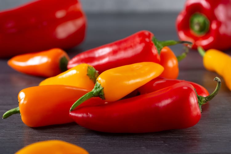 Sweet peppers on a wooden table.