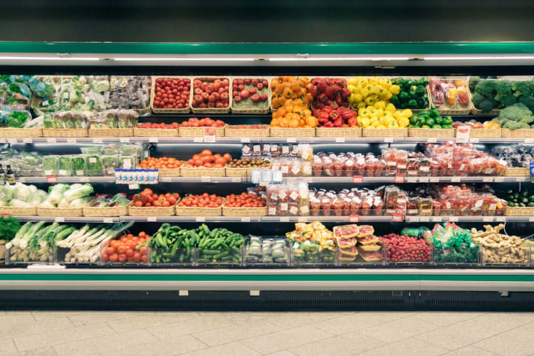 A well-stocked fresh produce section at a grocery store.