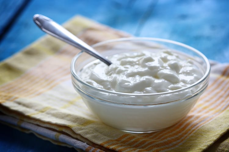 Sour cream in a transparent bowl depicting and answering — how long is sour cream good for after opening?