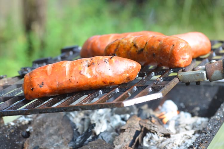 Side, close-up view of sausages being cooked on a hibachi grill