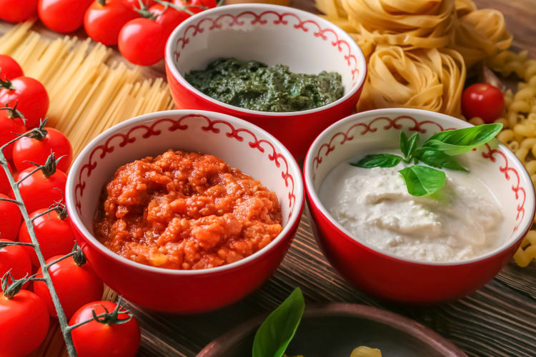 Three bowls with different sauces showcasing the differences between marinara vs. pasta sauce